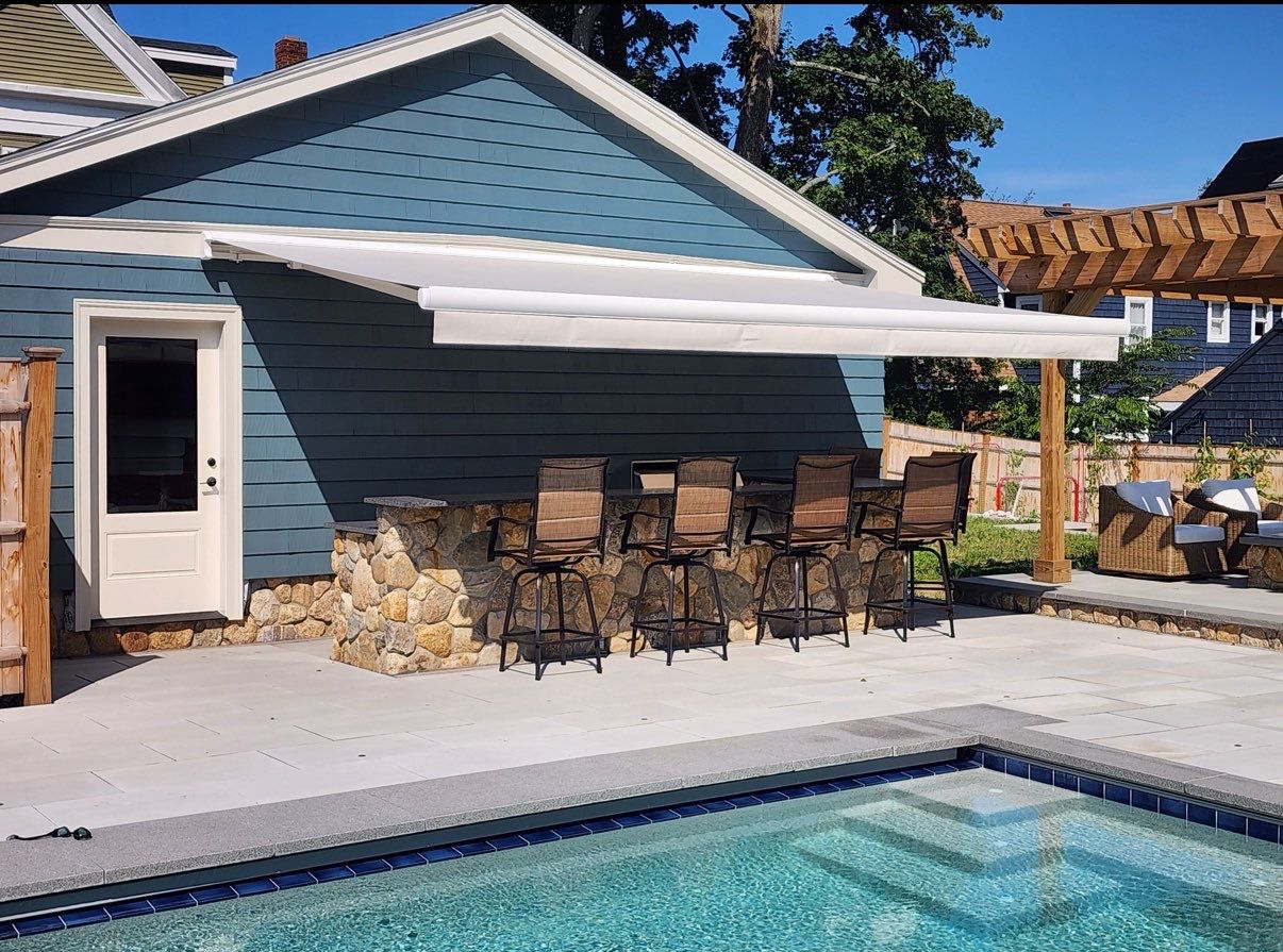 Fancy retractable awning for pool deck bar area, manufactured and installed by Atlantic Awning